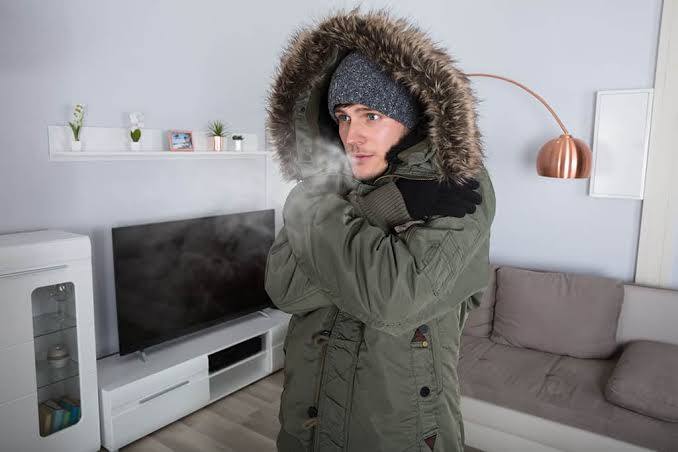 Homeowner bundled up in a cold home with no heat